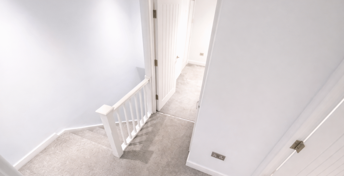 Bright upstairs landing with open doorway