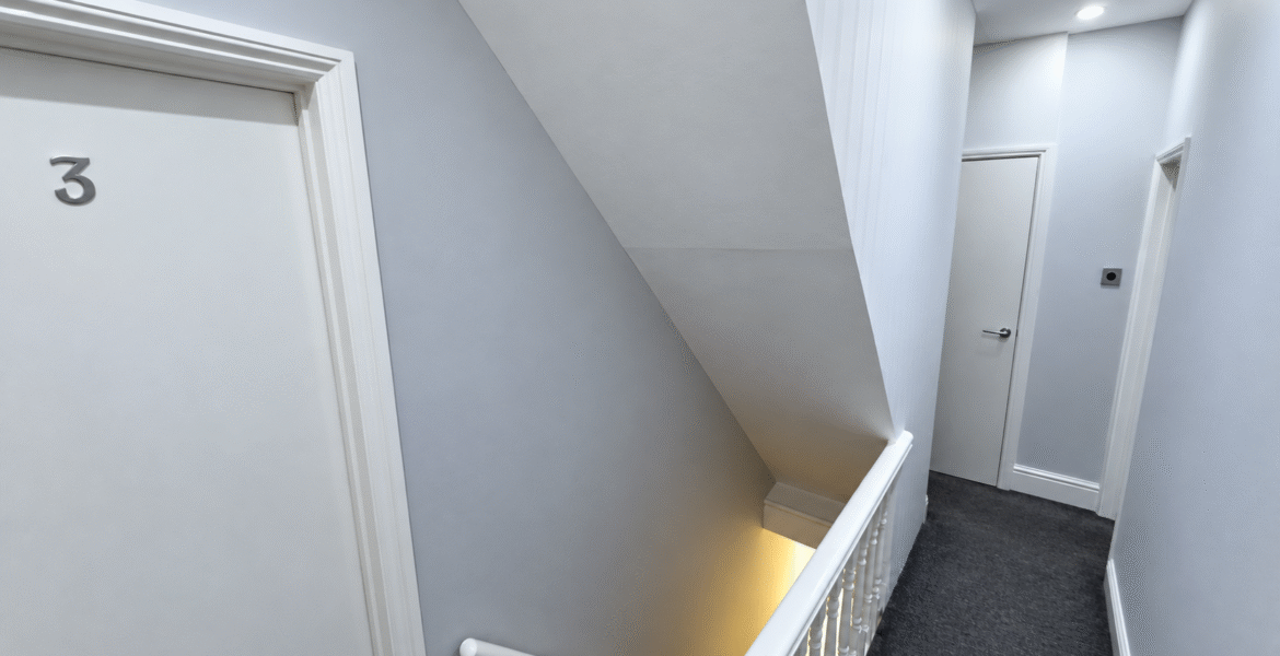 Minimalist Stairwell Landing with Door Three
