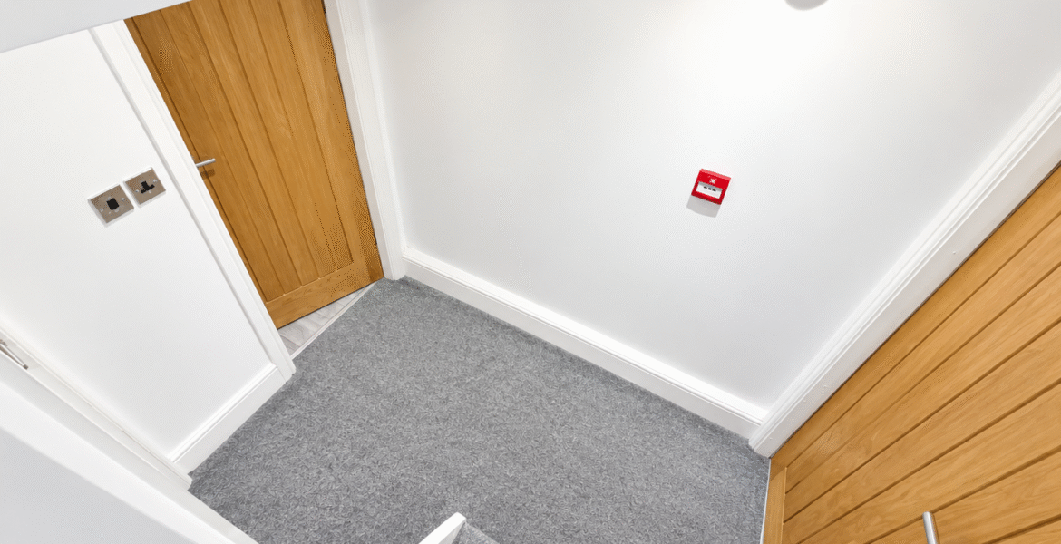 Modern Staircase Landing with Red Alarms