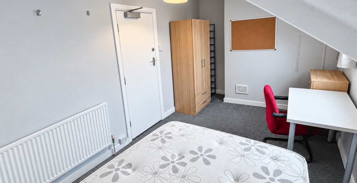 Tidy Attic Bedroom with Red Chair
